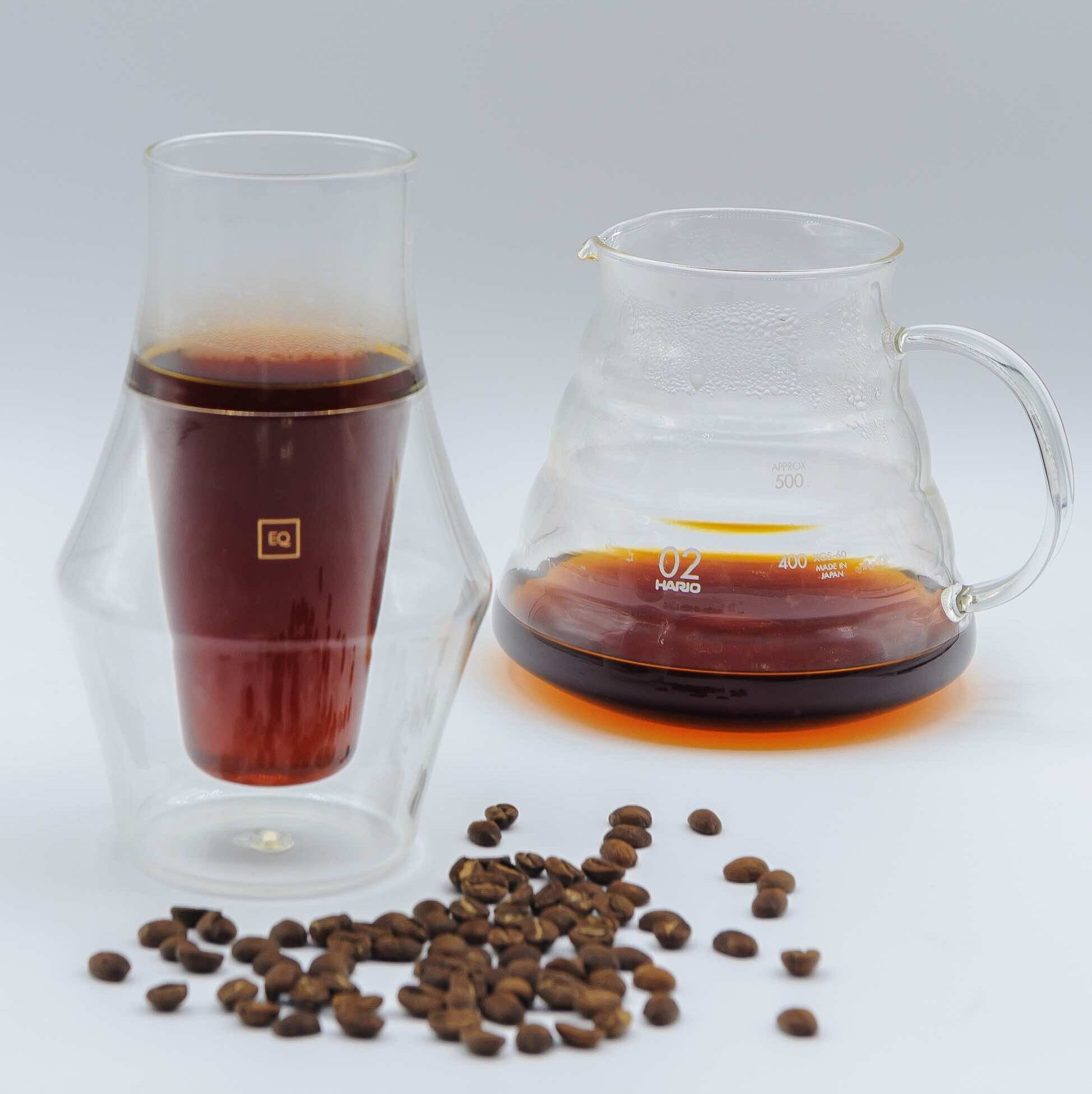 Bora Nera specialty coffee make by coffee drip, served in a glass for tasting, front view